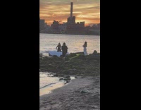 Model on air bed near river 