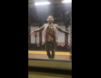 Man wearing headphones dance at subway platform