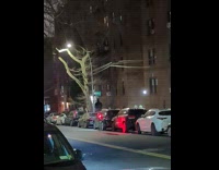 Man rides a tall unicycle on the street 