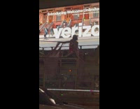 Shirtless man sit on couch over bus