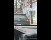 Woman red top supplies carry tripod sidewalk