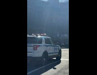 Collab WINY - Policeman in Dirt Bike Leads Police Cars on Street