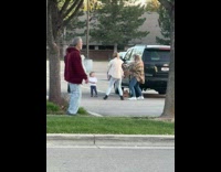 Kid girl watch sisters dance parking lot