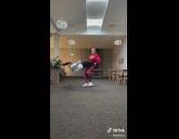 Lady Holds Friend on Legs then Spins her Around