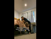Girl tries to get dog off bed 