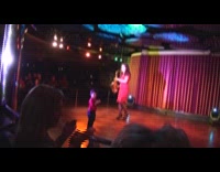 Woman plays saxophone with kid on stage