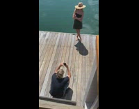 Black dress straw hat girl lake dock 