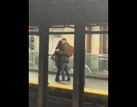 Couple Swings as they Dance on Subway Platform