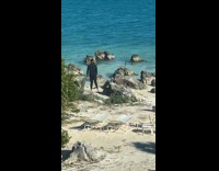 Man timer photoshoot by the beach rocks