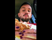 Guy eats vegetarian burger