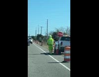 Road worker dancing on roadside 