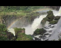 Rainbow shines above waterfalls 