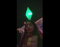 Girl in white robe with Sims diamond light up on her head 