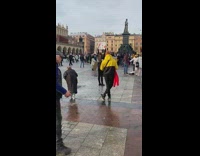 Woman poses with a poster to support Ukraine