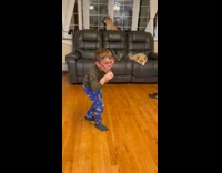 Kid spinning around and dancing takes a shot and then keeps dancing