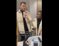 Couple wears the same outfit in bathroom