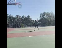 Guy throws basketball misses shot outdoor court 