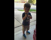 Litle kid excited about starting red car with remote exhaust loud