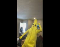 Guy filming video in banana outfit and housemates walk in