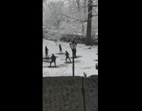 People work out with swords in snowy park