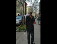 Guy walks with puppet doll on shoulder