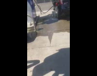 Water fills up car at gas station 
