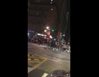 Large group of guys crowd street night 