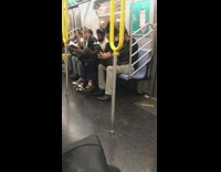 Woman reads book titled White fragility on subway train