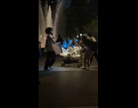 Man ride shopping cart with lights park