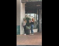 Woman look up in front of the wall near the plant for photoshoot