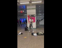 Guy plays song on electric cello 