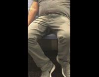 Guy wet stain on pants subway train 