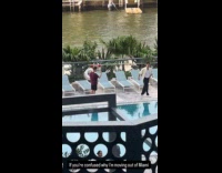 Man strips off top for poolside video