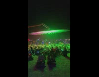 Group of people under spinning colorful fan 
