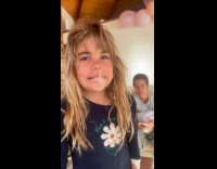 Snot bubble hang from nose of girl