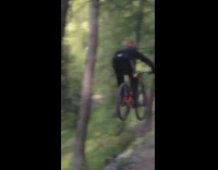 Guy long jump on red bicycle dirt