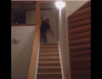 Black shirt long hair guy alex summersaults down wooden stairs