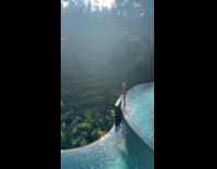 Collab IITW - Woman red bikini walk on infinity pool