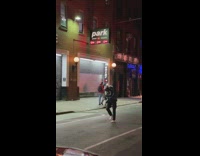 Guy waits for car to pass then tees off golf ball in the middle of street