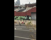 Group of people do choreographed dance outside  