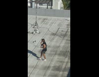 Man sings with camera mounted on his waist at the rooftop