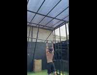 Guy does tricks and spins on bar 