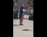 Guy dressed in Uncle Sam costume standing on sidewalk