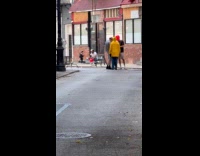 Person with red balloon wear yellow hoodie