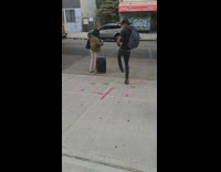 Man with back pack jumping around one foot