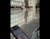 Woman take selfie with stick airport windows