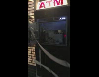 ATM open and broken into, receipt paper blows in the wind