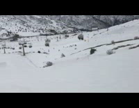 Snowboarder jumps off ramp and lands on knees