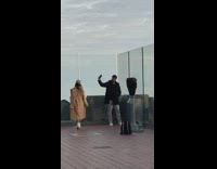Man and woman selfie nearby rooftop building