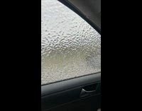 Frozen rain water pushed and cracked on the car window